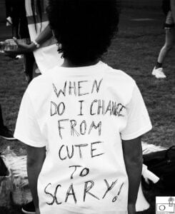 A person wearing a T-shirt with the text: When do I change from Cute to Scary